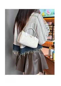 Boston bag with butterfly hardware and chain strap shown on model in street setting