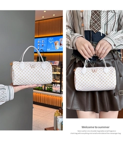 Macro view of white mini boston bag with butterfly metal clasp and printed patterns