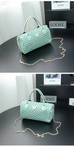 Detail of mint green Boston bag with butterfly hardware and geometric pattern texture