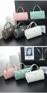 Detail of printed boston bags with butterfly metal hardware and golden chain straps