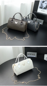 Detailed close-up of three printed barrel bags featuring vintage patterns and butterfly clasps