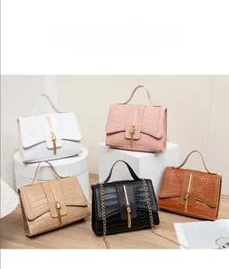 Detail of crocodile pattern leather handbags in five colors with gold chain and tassel