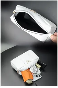 White chevron quilted camera bag detail showing spacious interior and golden butterfly buckle