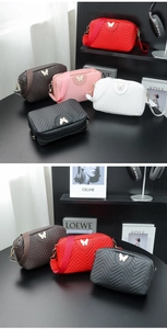 Close-up of five quilted camera bags with gold butterfly buckle and wide shoulder straps