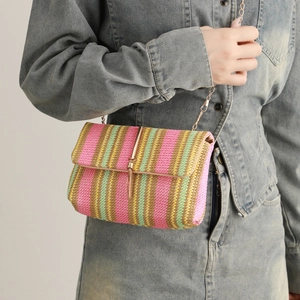 Handwoven rainbow striped crossbody bag with gold chain strap and decorative tassel