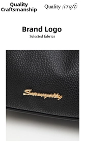 Macro shot of black litchi grain leather texture and gold metal logo on shoulder bag