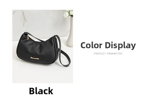Detail of black lychee pattern leather shoulder bag with golden zipper and metal logo