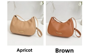 Detail view of apricot and brown lychee grain leather underarm bags with gold metal logo