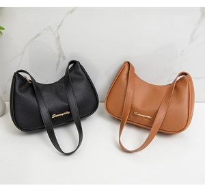 Detail of lychee pattern faux leather underarm bags in black and caramel brown colors