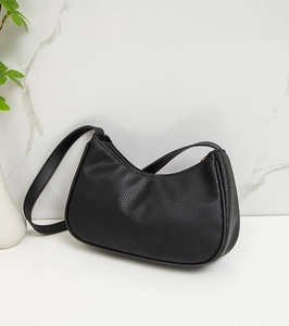 Close-up of the textured lychee grain leather and sleek zip closure on the black hobo bag