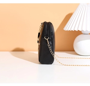 Vue détaillée du double zip et du pendentif chat sur le sac brodé de fleurs