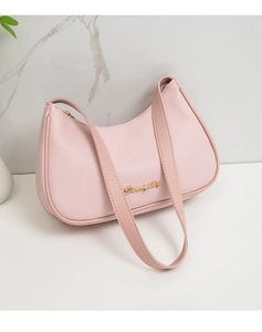 Detail of pink lychee leather texture and golden metal logo on the hobo underarm bag