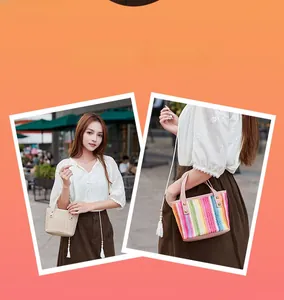 Detail of woven straw tote bags with vertical rainbow stripes and leather rivet handles