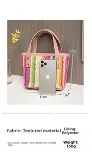 Detail of colorful woven straw bag with pink leather handles and gold stud accents