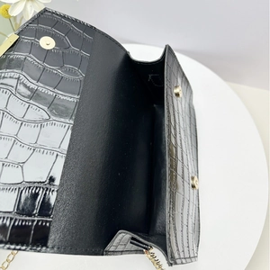 Black crocodile embossed leather crossbody bag with gold chain and magnetic buckle closure