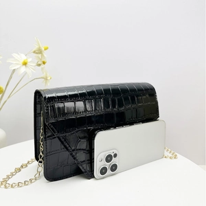 Mini black crocodile embossed square flap bag with gold chain strap and glossy finish