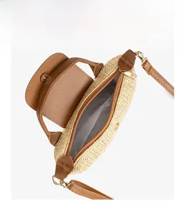 Macro shot of the straw crossbody bag showing interior storage and leather handle