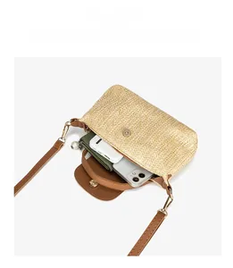 Internal view of straw crossbody bag showing space for phone, power bank and wallet