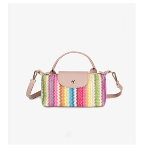 Macro detail of bohemian rainbow straw weave texture and pink strap on square crossbody bag