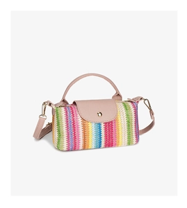 Detail view of colorful woven straw mini bag with pink leather flap and gold hardware
