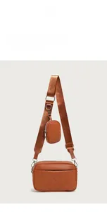 Detail of brown quilted camera bag with matching round pouch and nylon shoulder strap