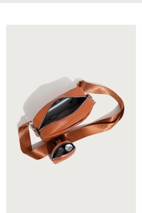 Interior view of brown faux leather quilted crossbody bag with small round pouch detail