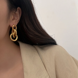 Matte gold triple interlinked hoop earrings with minimalist geometric chain design