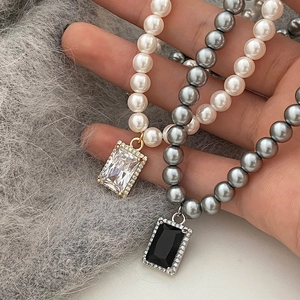 Luxe pearl necklace set with rectangle crystal pendants and sleek OT buckle closure
