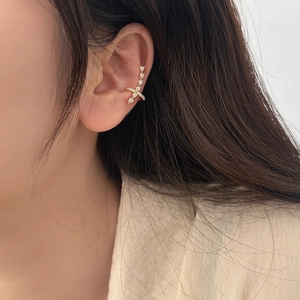 Minimalist gold ear cuff with sparkling crystals and elegant crisscross design