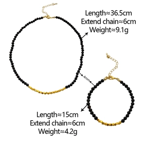Detail of beaded necklace and bracelet set with black stones and gold spacer beads