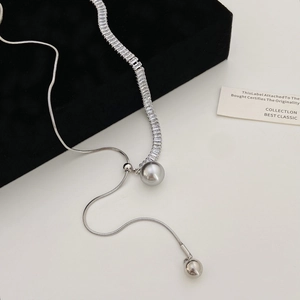 Macro detail of silver snake chain with cubic zirconia inlay and metallic beads