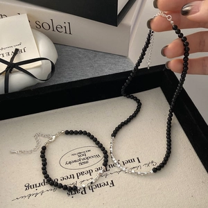 Black beaded necklace and bracelet set with silver accents for a minimalist chic look