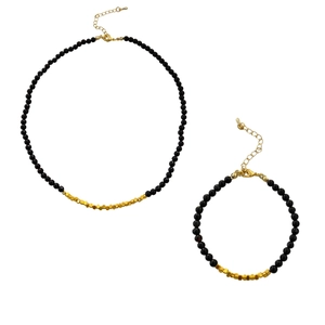 Elegant black beaded necklace and bracelet set with golden hexagonal charms and clasps