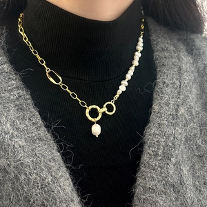 Minimalist mixed design necklace featuring golden paperclip chain and irregular pearls