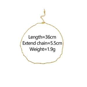 Detail of minimalist gold chain necklace featuring small round discs and lobster clasp