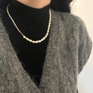 Baroque freshwater pearl necklace with gold rhinestone chain shown on a model