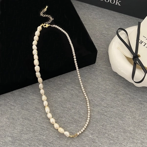 Detail of baroque pearl necklace with gold rhinestone chain and lobster clasp