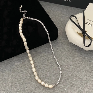 Detail of baroque pearl and sparkling rhinestone tennis chain necklace with silver clasp