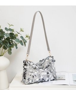 Détail du sac à bandoulière en paillettes argentées avec bandoulière en cuir gris chic