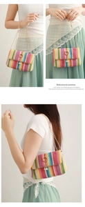 Close-up of rainbow woven straw bag with gold chain strap and pearl pendant detail
