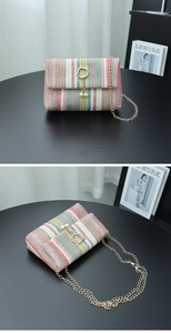 Detailed view of colorful striped straw woven bag with gold cat ear buckle and chain strap