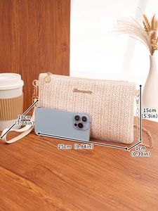 Detail of woven straw crossbody bag with gold chain strap and smartphone size comparison