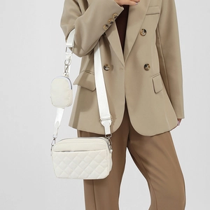 White quilted crossbody camera bag with wide strap and mini round coin purse charm
