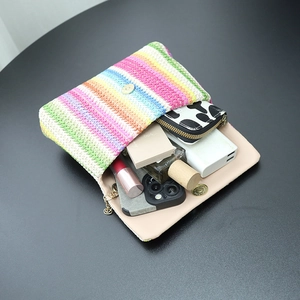 Rainbow striped woven crossbody bag with metal lock showing daily storage capacity