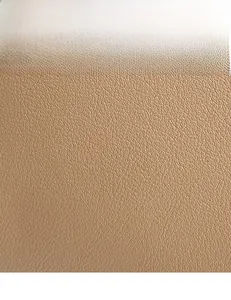Macro detail of high-quality light brown lychee textured leather on a crossbody bag
