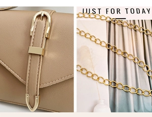 Detailed close-up of golden horseshoe hardware and fine chain strap on a khaki PU bag