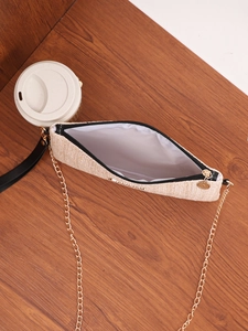 Detail of woven square crossbody bag with gold chain strap and zip closure inside