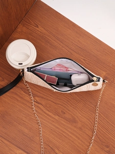 Internal view of a woven straw bag showing storage for phone, lipstick, and essentials