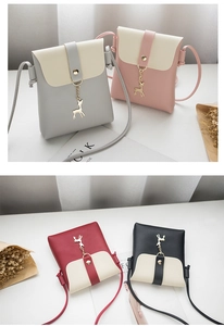 Detail of trendy phone pouch showing various colors with cute golden deer charm decoration