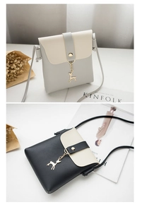 Detailed view of mini phone pouch featuring a golden deer charm and contrast colors